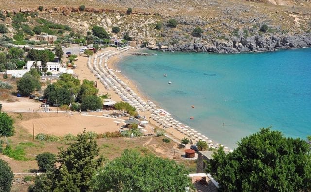 Lindos Beach In Rhodes - Courtesy Of MJJR (Wikimedia Commons)